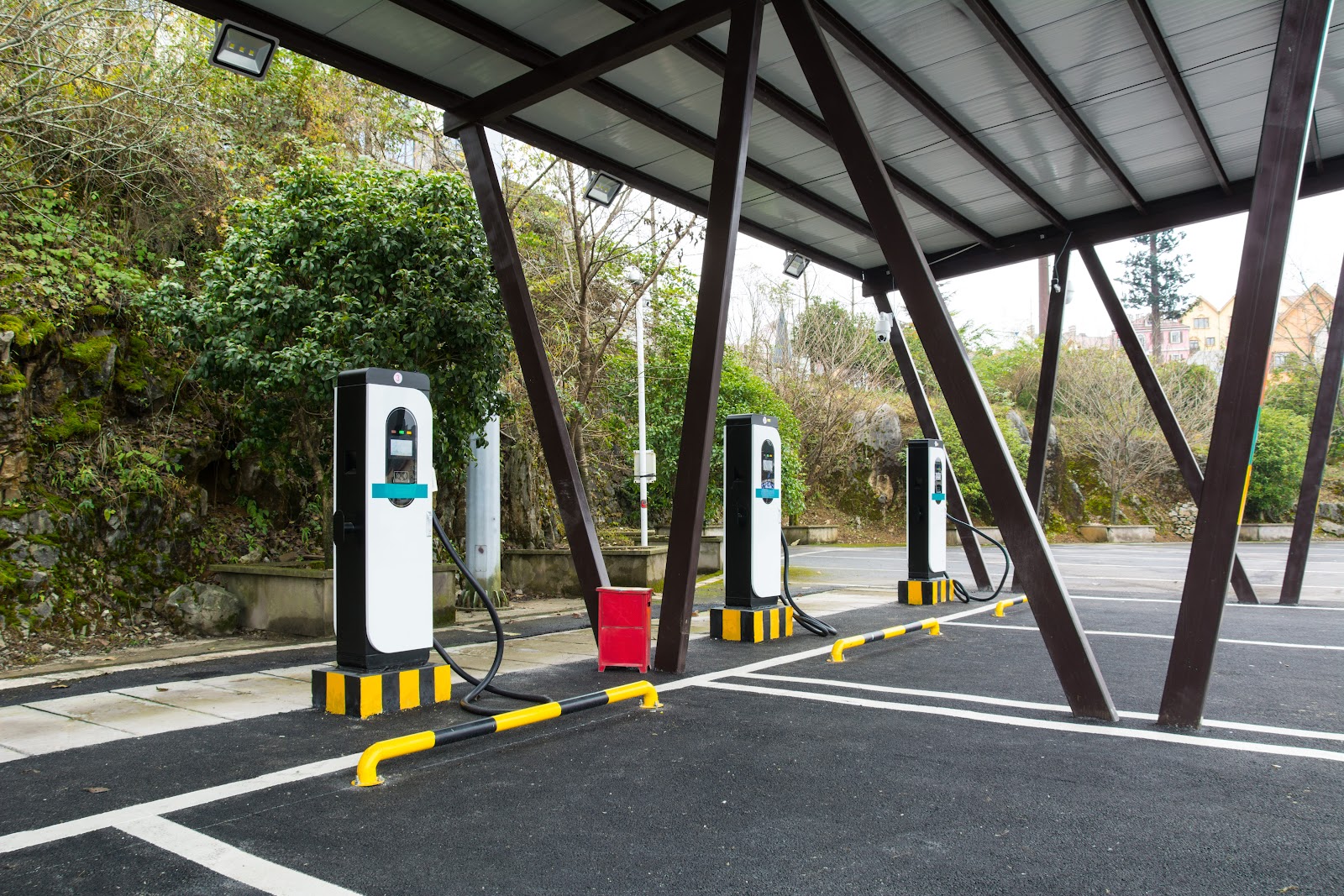 A bank of commercial EV charge points under a canopy — larger-scale charging infrastructure.